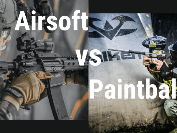 gracze airsoftu i paintballu z bronią stojący obok siebie na polu bitwy